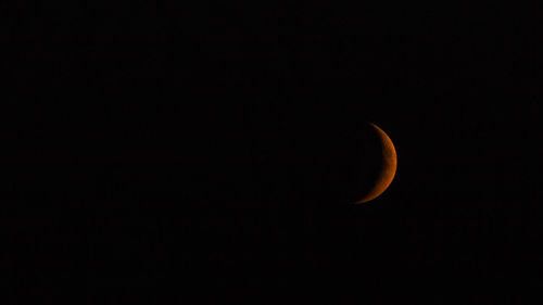 Low angle view of half moon against sky at night