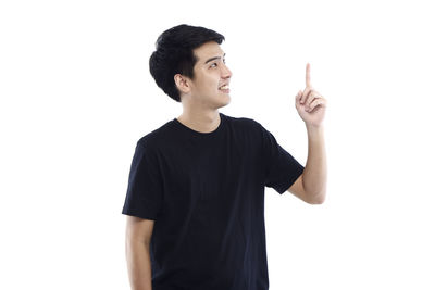 Young man looking away against white background
