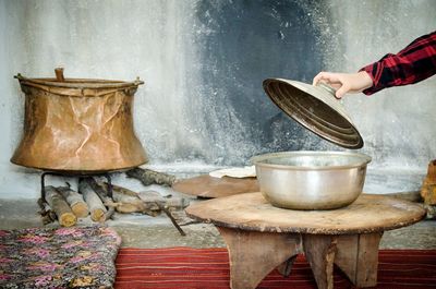 Cropped hand holding lid of container