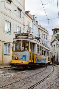 View of railroad tracks by buildings in city
