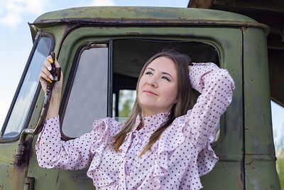 Portrait of beautiful young woman in car