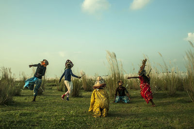 Children on field against sky