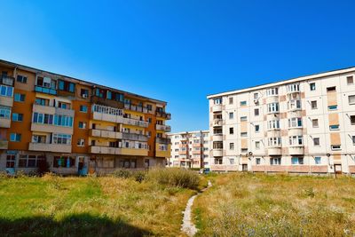 Buildings against clear blue sky