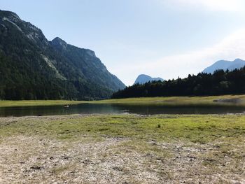 Scenic view of lake and mountains against sky