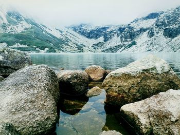 Scenic view of lake by snowcapped mountains