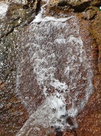 High angle view of water flowing through rocks