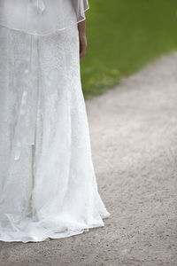 Low section of wedding dress