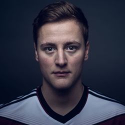 Close-up portrait of young man against black background