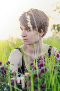 Close up thoughtful lady sitting in fresh grass portrait picture