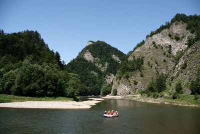 Scenic view of river and mountains against clear sky