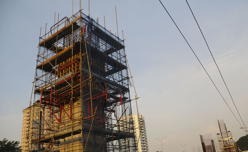 Low angle view of construction building against sky