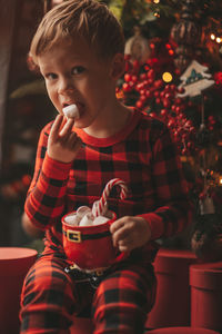 Portrait of cute girl eating food at home