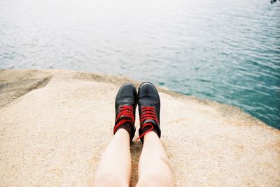 Low section of woman standing on beach