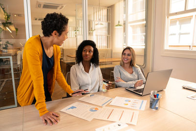 Women standing on table at home