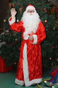 Midsection of man with christmas tree