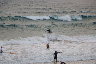 High angle view of people enjoying on beach against sea