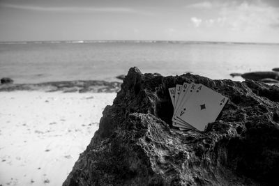 Close-up of rocks on beach against sky