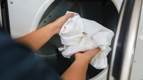 Midsection of woman washing hands in car