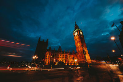 Illuminated buildings against sky at night