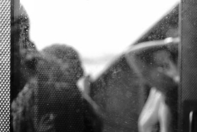 Close-up of couple kissing against water