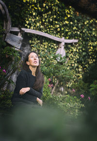 Woman in romantic pose between rustic houses, slovenia vi