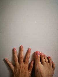 Close-up of hands against wall