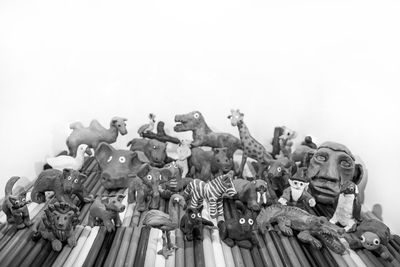 Low angle view of statues against white background