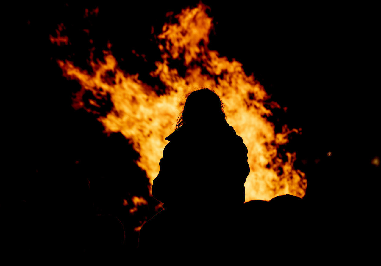 SILHOUETTE PEOPLE AGAINST ORANGE FIRE