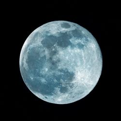 Low angle view of moon against sky at night