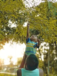 Portrait of boy with arms raised in park