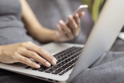 Midsection of woman using mobile phone