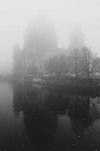 Scenic view of river against sky during foggy weather