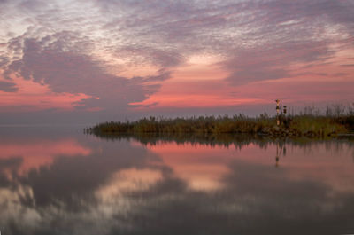 Scenic view of lake against sky at sunset