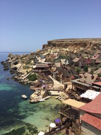 High angle view of buildings by sea