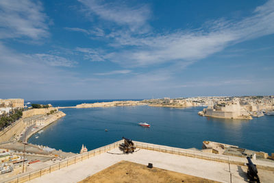 Grand harbour of malta with the ancient walls of valletta on a sunny day.