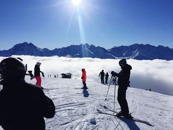 People skiing on snow covered landscape