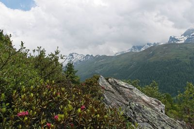 Scenic view of mountains against cloudy sky