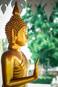 Statue of buddha against building