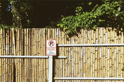 Information sign on plant by fence