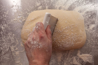 Close-up of hand preparing bread