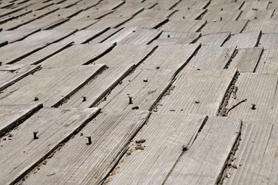 Full frame shot of vintage wooden roof planks with nails