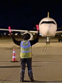 Man marshaling airplane