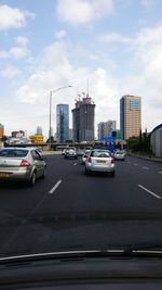 Traffic on road with buildings in background