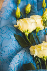 Close-up of yellow rose flower on table