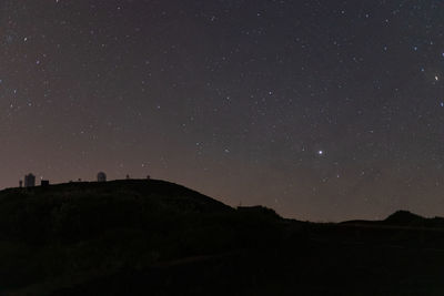 Scenic view of silhouette landscape against sky at night