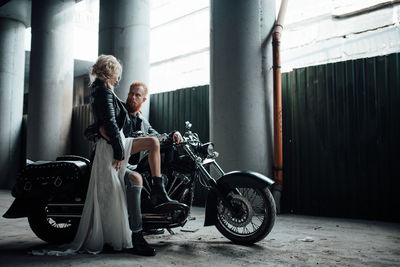 Young couple sitting on motorcycle