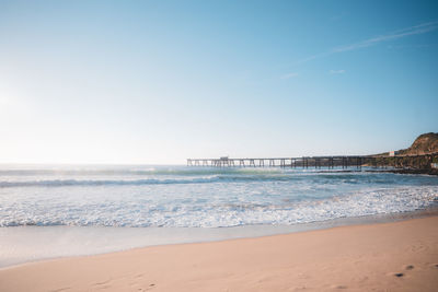 Scenic view of beach against clear sky