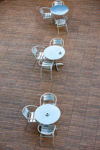 High angle view of empty chairs and table in cafe