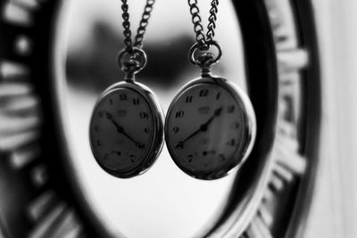 Close-up of pocket watches hanging at home