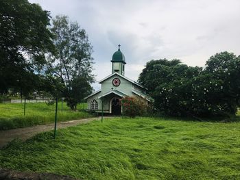 Church by building against sky
